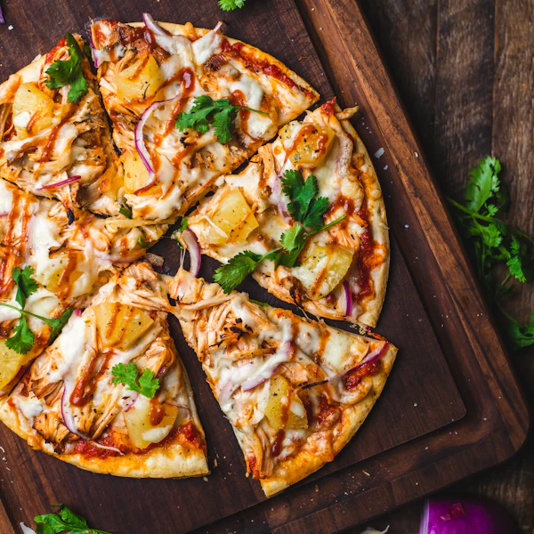 A sliced pizza on a wooden board