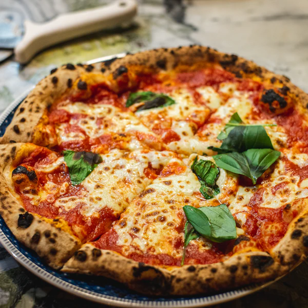 A margherita pizza with basil
