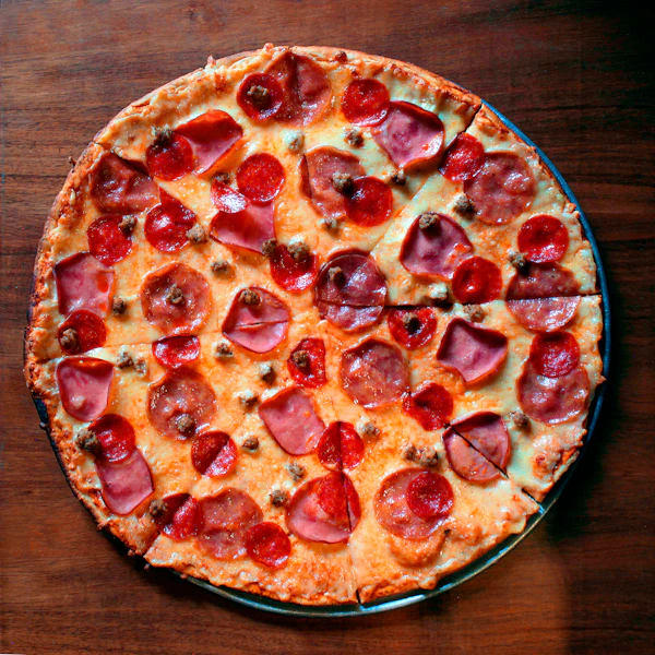 A salami pizza on a wooden board