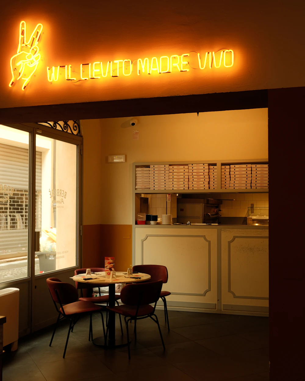 Inside a small pizza shop at night